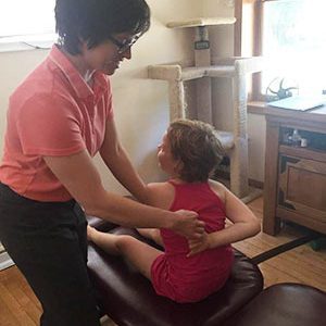 Chiropractor St Paul MN Kayla (Zirpel-Proctor) Orr Adjusting Childs Back